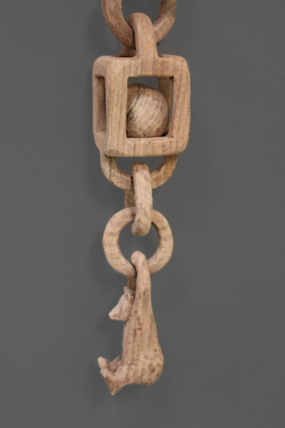Lower components of wooden chain after 
		first sanding.