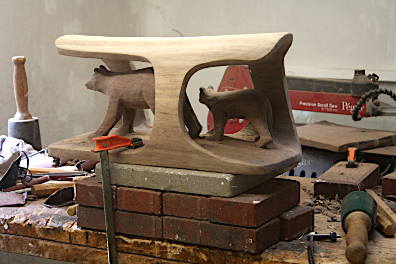 Bear with cub carved in black walnut log.